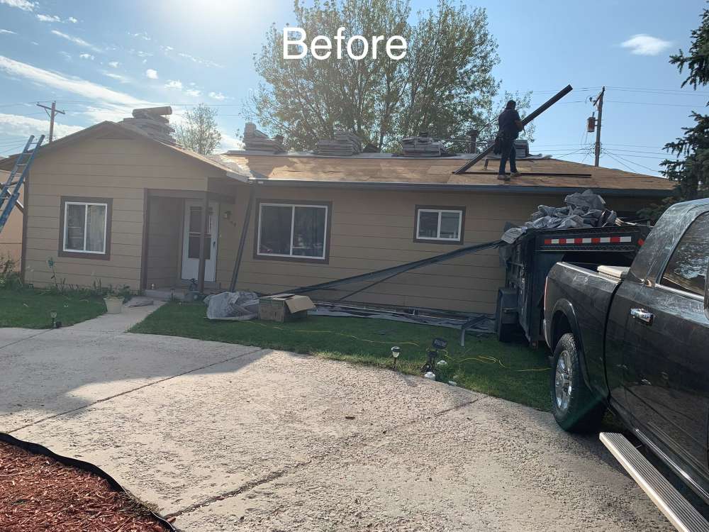 A tan house with its old roof being removed; one worker stands on the roof, tools and materials are scattered, and a black truck is parked nearby. The word "Before" appears at the top of the image.